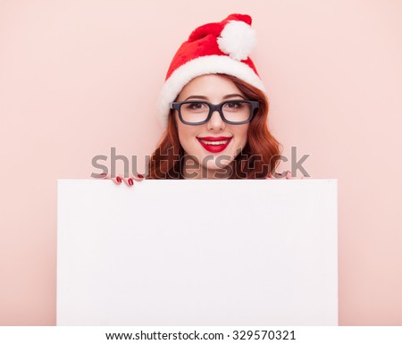 Young caucasian girl in glasses and Hat with white board on pink background.