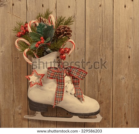 Christmas decoration with vintage skate on wooden wall
