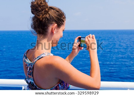 Woman taking photos of events and landmarks on the road to travel destination.