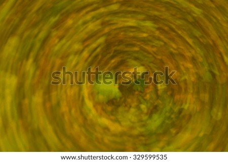 Abstraction of forest at autumn. Colorful background photographed with long exposure and motion effect.