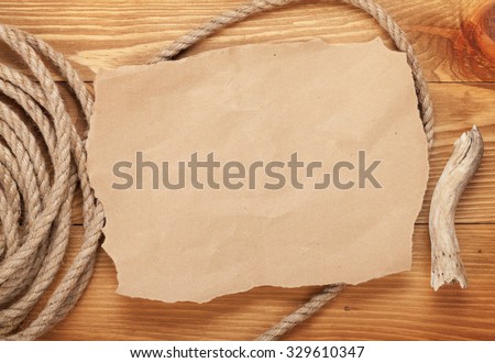 Old paper for copy space and rope on wooden textured background
