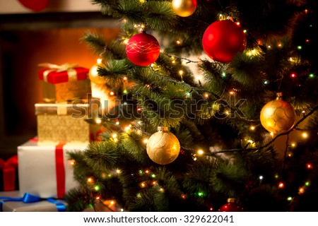 Christmas background with illuminated fir tree and fireplace at house