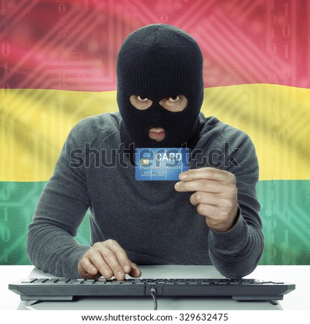 Dark-skinned hacker with credit card in hand and flag on background - Ghana