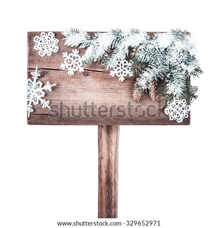 Wooden road sign with Christmas tree in the snow. New Year background