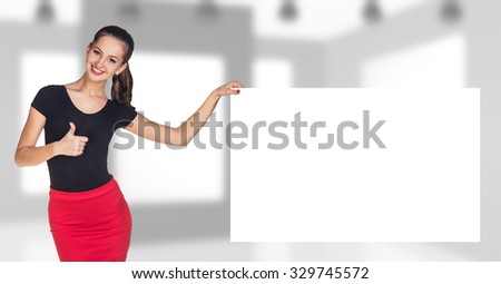 Business woman stands near empty board on the office background