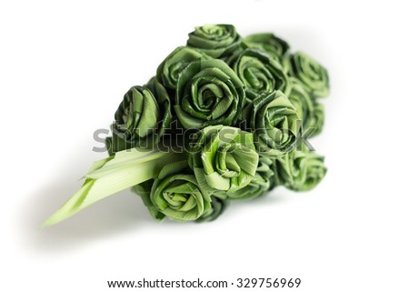 Fresh Pandanus leaf weave to rose bouquet isolated on white background. (selective focus)
