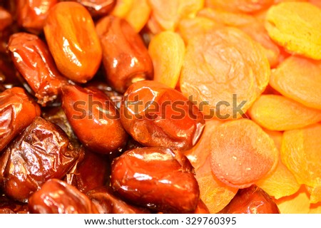 Dried fruits: delicious dates and dried apricots closeup