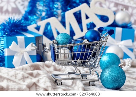 Christmas decoration with ornaments and small trolley in blue.