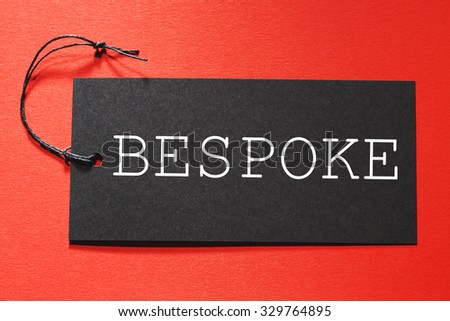 Bespoke text on a black tag on a red paper background