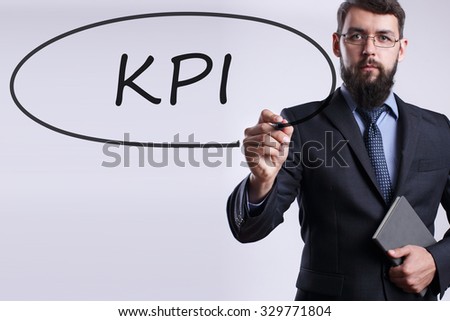 Businessman writing KPI with marker on transparent board. Business, internet, technology concept.