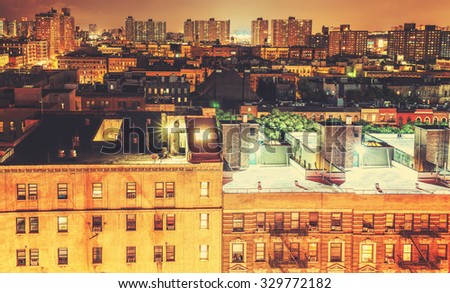 Retro toned Harlem neighborhood at night, NYC, USA.