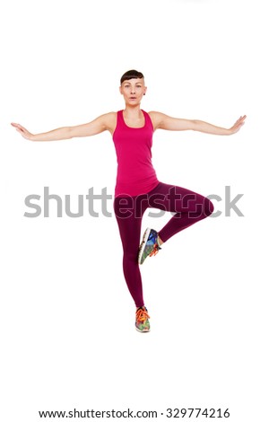 Young fitness woman balance, isolated over white background.