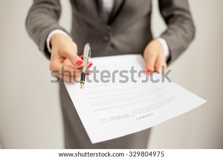 Woman offering to sign papers Royalty-Free Stock Photo #329804975