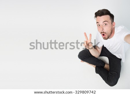 Narcissistic black-haired bearded man makes salfe. Isolated on light background
