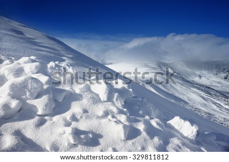 Slope in the mountains covered with fluffy snow