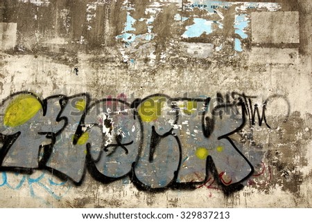 Urban Old Concrete Graffiti Wall With Peeled Paint And Ripped Ads Background Texture