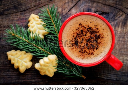Good morning or Have a nice day Merry Christmas message concept - Cup of coffee with Christmas tree shape cookies and fresh fir or pine branch. Filtered