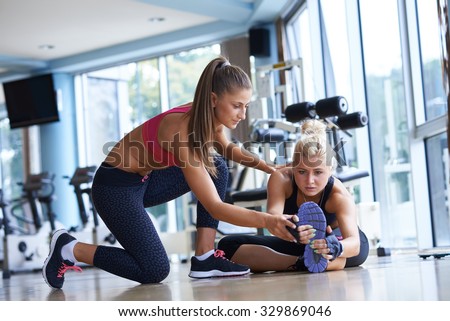 woman exercise and  working out with fitness personal trainer in gym Royalty-Free Stock Photo #329869046