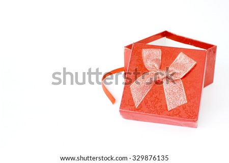 Red gift box and red ribbon on white background with space for text
