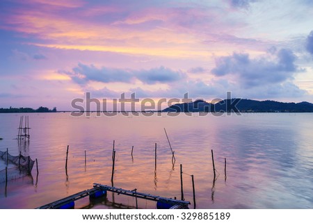 Blurred abstract background of Songkhla Lake in evening.