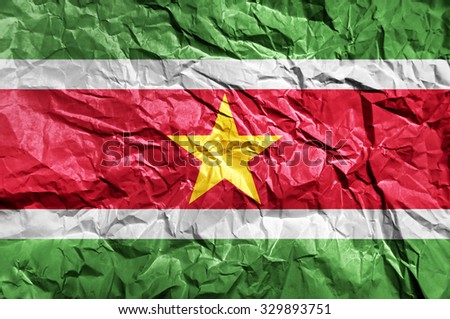Suriname flag painted on crumpled paper background