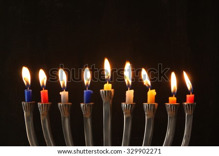 Image of jewish holiday Hanukkah background with menorah (traditional candelabra) and Burning candles
