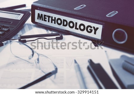 Office folder with inscription Methodology on Office Desktop with Office Supplies. Business Concept on Blurred Background. Toned Image.