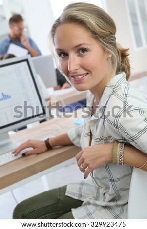 Portrait of student girl working on desktop computer