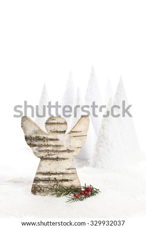 christmas angle made from birch bark with artificial snow, trees and decoration