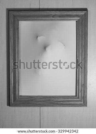 Creepy Bland and White Picture Frame with Something Coming Out of It