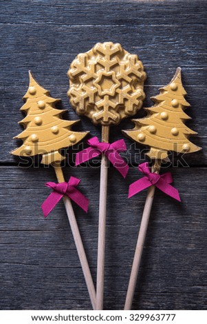 Christmas tree and star chocolate candy on wooden table