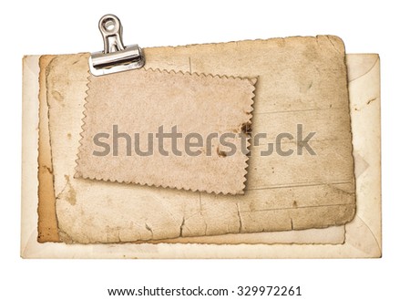 Blank aged paper sheets with metal clip isolated on white background. Used cardboard