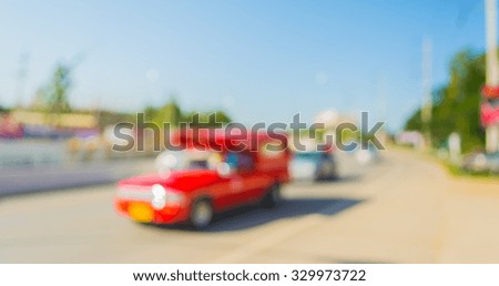 abstract blurred of traffic in day time blur of car in the road for background usage.