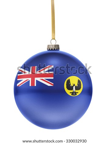 A glossy christmas ball in the national colors of South Australia hanging on a golden string isolated on a white background.(series)