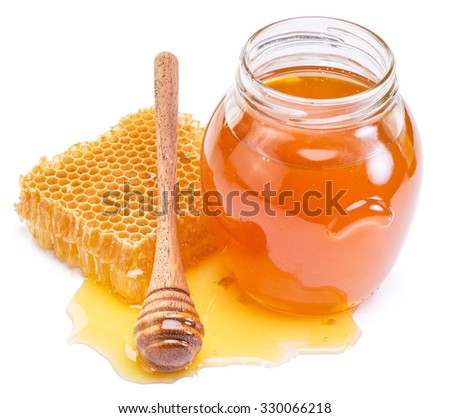 Jar full of fresh honey and honeycombs. High quality picture.
