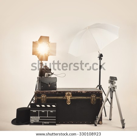 A retro vintage camera with studio lights and various photography lighting equipment for a director or film concept.