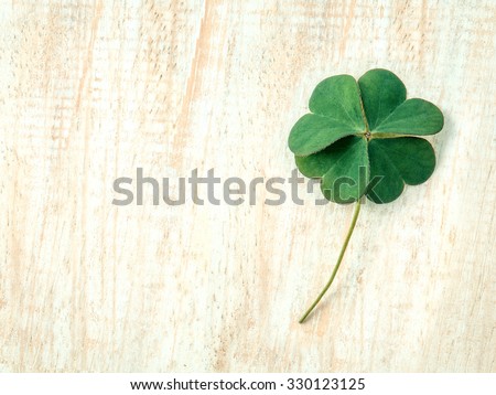 Closeup clovers leaves  setup on wooden background. Royalty-Free Stock Photo #330123125