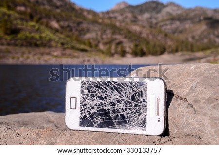 Broken Modern White Smartphone on the Floor