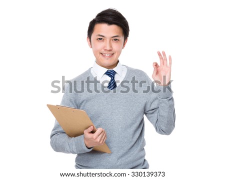 Asian Businessman hold with clipboard and ok sign gesture