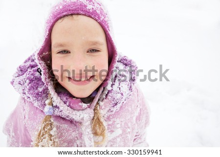 Child in winter. Happy girl on snow