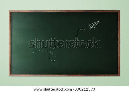 hand-drawn paper plane fly on chalkboard background
