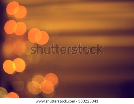 Christmas background. Festive abstract background with bokeh defocused lights and stars, orange, gold colors