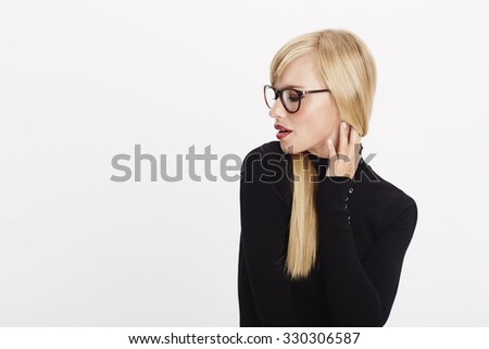 Cool blond woman in black, studio