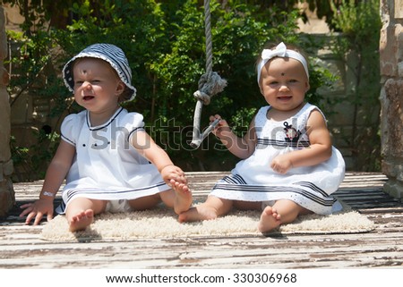 Picture of two baby child having fun playing outdoors, best friends, happy family, love and happiness concept