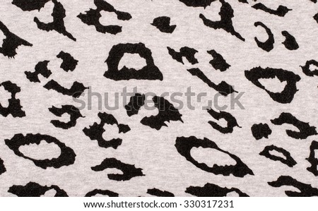 Black and gray leopard fur pattern. Spotted animal print as background. Sweater material.