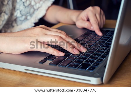 Women typing with laptop. on the wood office
