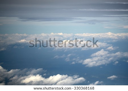 Panorama spectacular skyline view above sea of clouds in blue sky from airplane window over breath-taking tranquil earth background, horizontal picture 