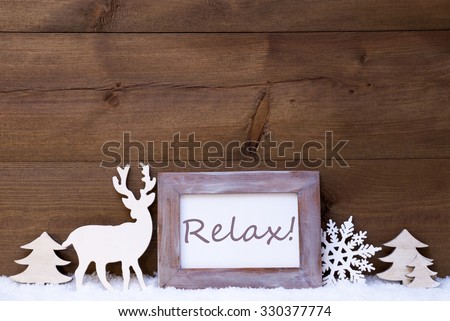 Christmas Card With Shabby Chic Picture Frame On White Snow. English Text Relax. Christmas Decoration Like Snowflake, Tree And Reindeer. Vintage, Wooden Background.