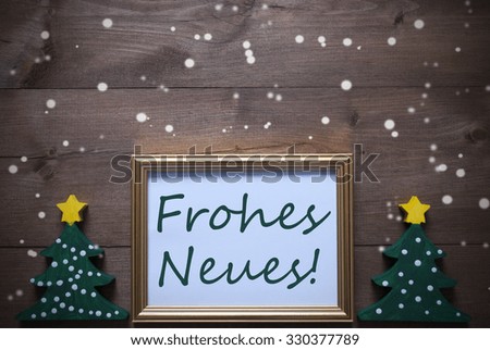 One Golden Picture Frame With Two Green Christmas Tree. German Text Frohes Neues Means Happy New Year. Christmas Card For Seasons Greetings. Decoration With Wooden, Rustic Background And Snowflakes