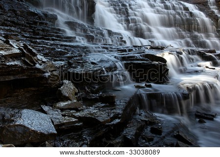 Rocky ledge and cascade waterfall.